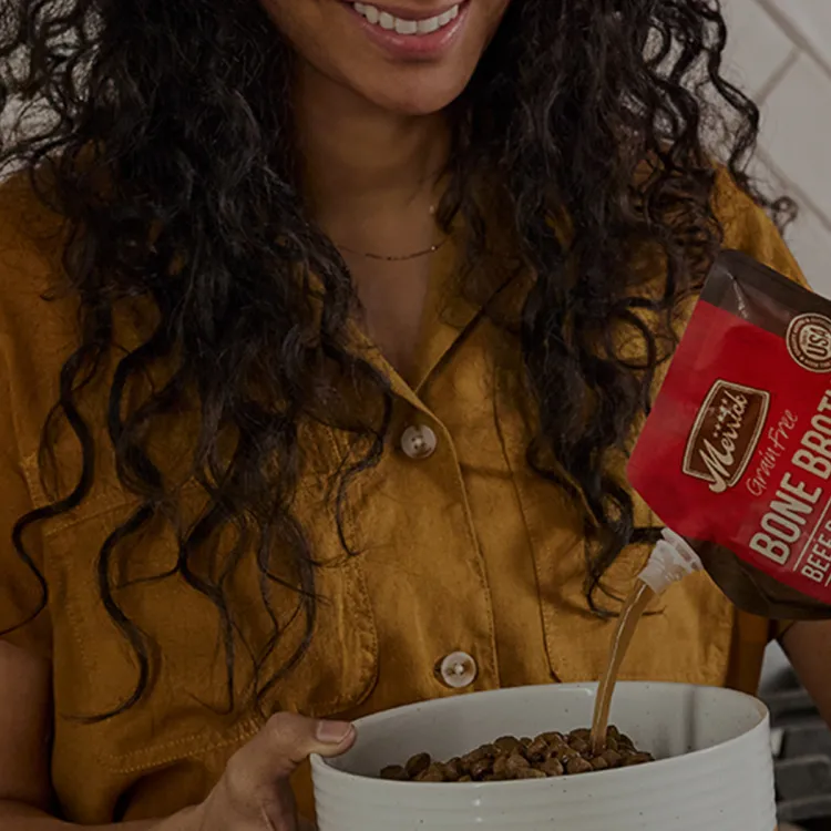 A woman pouring a bone broth into a bowl
