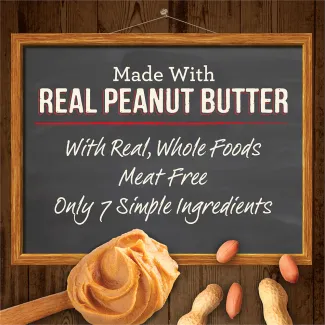 Peanut butter and a chalk board with the words “Made with real peanut butter. With real, whole foods. Meat free. Only 7 simple ingredients.” 